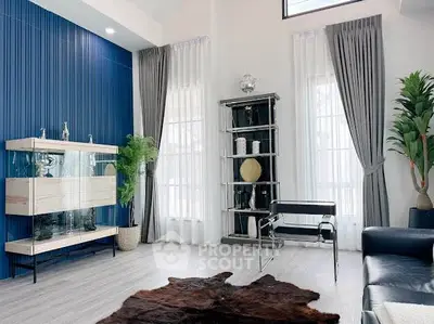 Modern living room with stylish decor and large windows