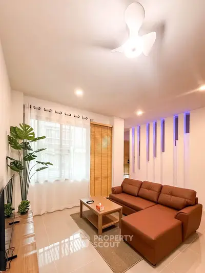 Modern living room with stylish decor and comfortable seating in a bright, inviting space.