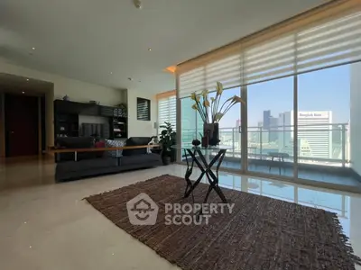 Luxurious living room with stunning city view and spacious balcony in modern apartment.