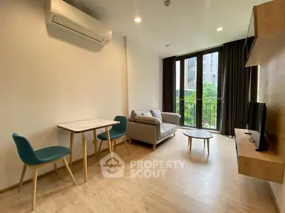 Modern living room with sleek furniture and large windows offering natural light.