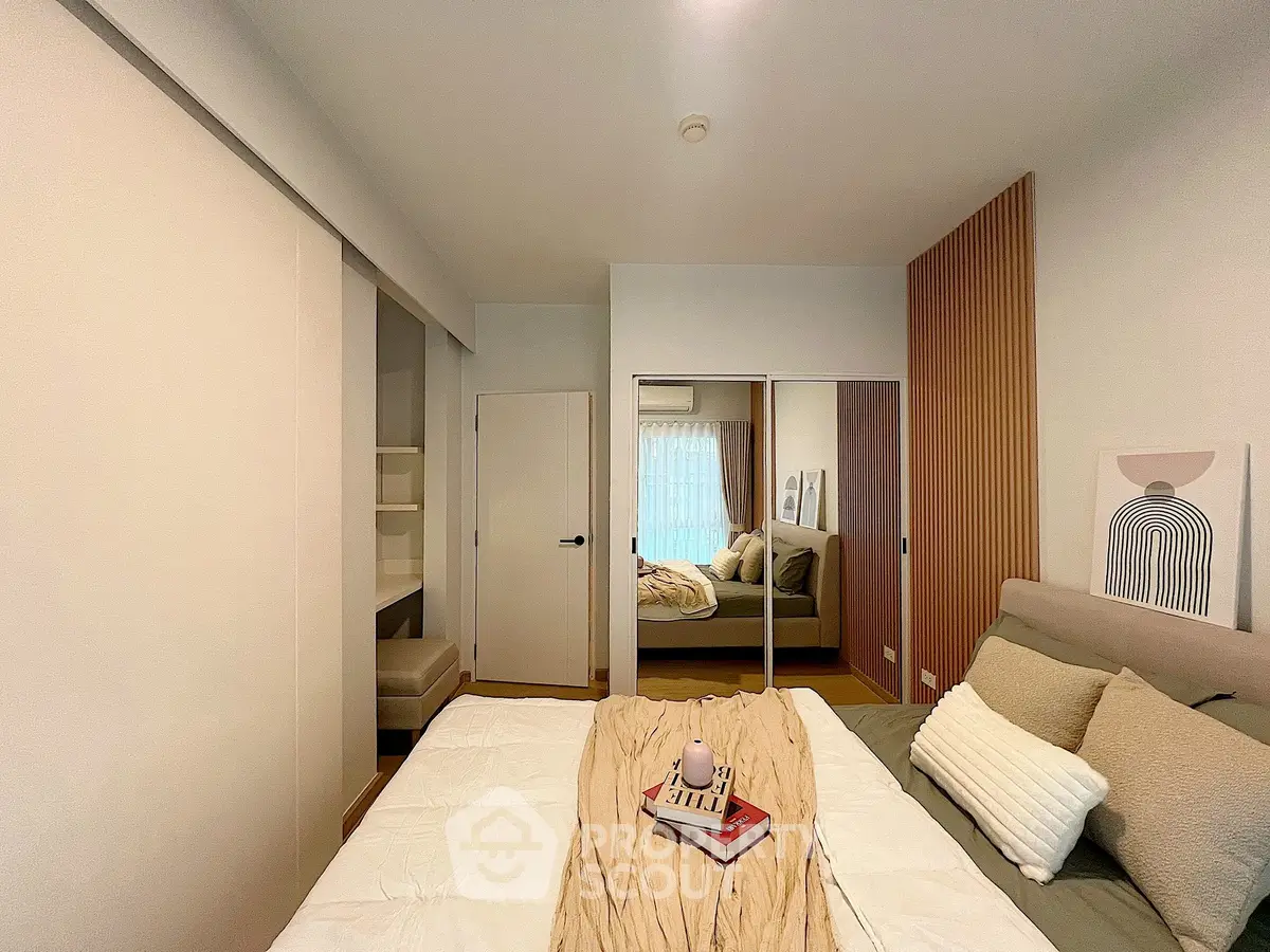 Cozy bedroom with modern decor and mirrored closet doors