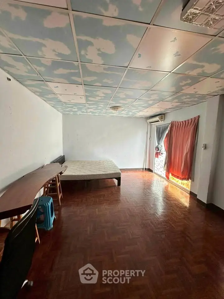 Spacious bedroom with unique cloud ceiling and parquet flooring