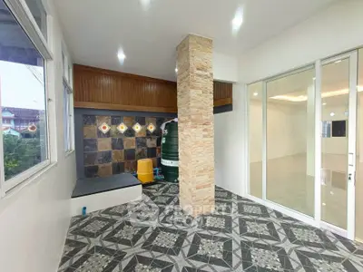 Spacious interior with unique tile flooring and stone accent wall, perfect for modern living.