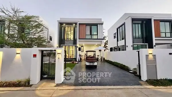 Modern two-story house with sleek design and spacious driveway