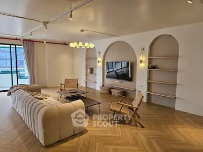 Spacious modern living room with elegant decor and large windows for natural light.