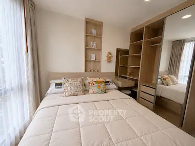 Cozy bedroom with modern wooden furniture and large mirrored wardrobe