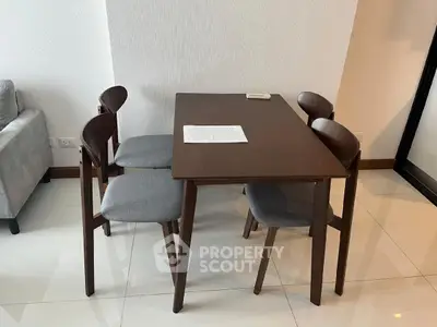 Modern dining area with sleek wooden table and chairs in a stylish apartment