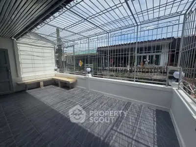 Spacious balcony with modern railing and tiled flooring, perfect for outdoor relaxation.
