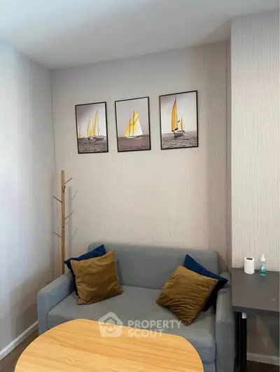 Cozy living room with modern decor and stylish wall art, featuring a comfortable sofa and wooden table.
