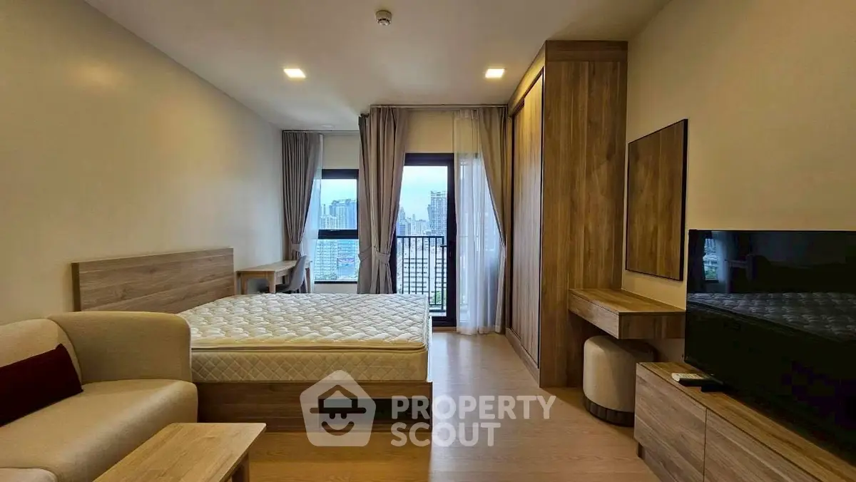 Modern bedroom with city view, featuring wooden furniture and a cozy ambiance.