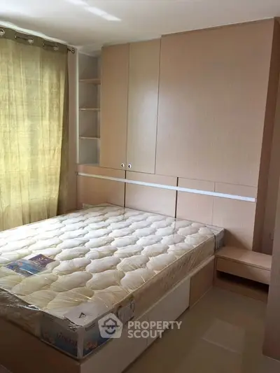 Spacious bedroom with built-in storage and natural light, perfect for modern living.
