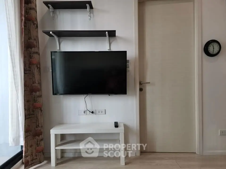 Modern living room with wall-mounted TV and minimalist decor
