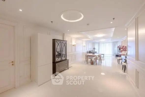 Spacious and elegant living room with modern decor and ample natural light.