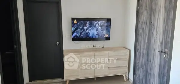 Modern living room with stylish wooden cabinet and wall-mounted TV