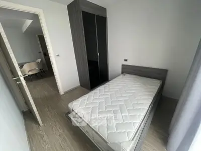 Modern minimalist bedroom with sleek wardrobe and cozy bed