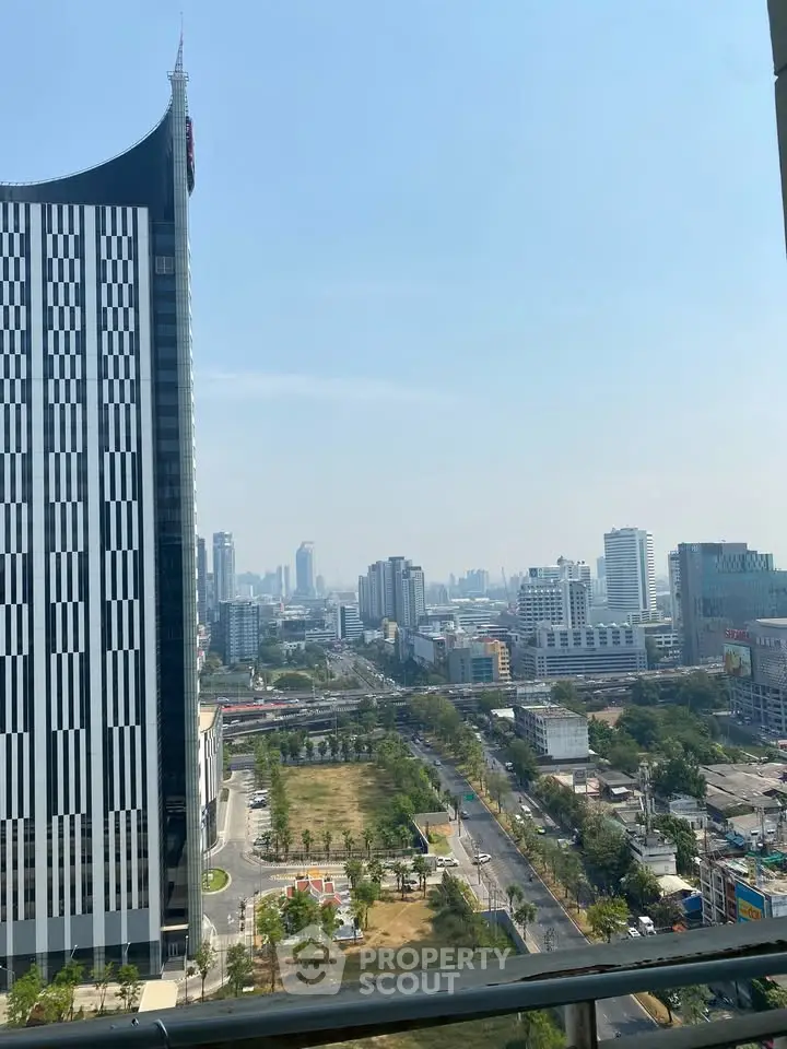 Stunning cityscape view from a high-rise balcony showcasing urban skyline and modern architecture.
