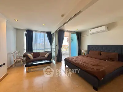 Spacious bedroom with balcony and modern furnishings in a luxurious apartment.