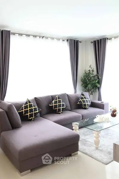 Modern living room with stylish gray sectional sofa and elegant decor