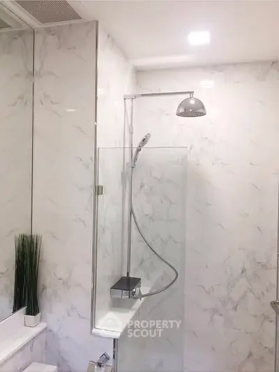 Elegant modern bathroom with marble walls and sleek shower design