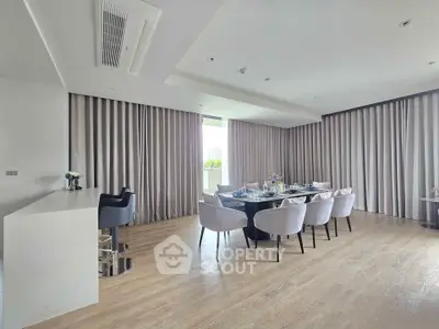 Spacious modern dining area with elegant decor and large windows for natural light.
