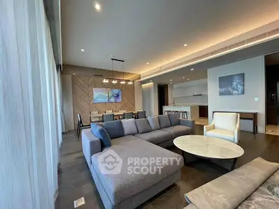 Spacious modern living room with elegant decor and open kitchen layout.