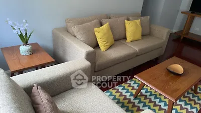 Cozy living room with stylish beige sofas and vibrant zigzag rug