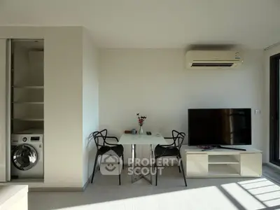 Modern living room with sleek furniture and built-in laundry area