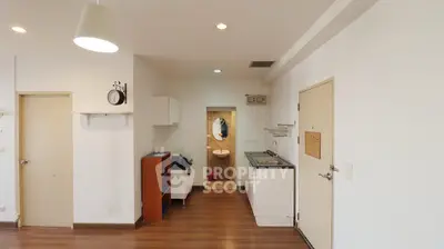 Spacious apartment interior with modern kitchen and wooden flooring