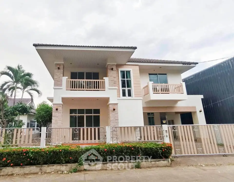 Stunning two-story modern house with spacious balconies and lush garden, perfect for family living.