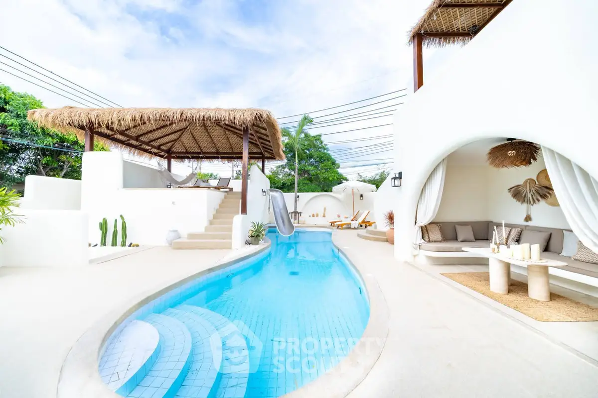 Luxurious villa with private pool and stylish outdoor lounge area, perfect for relaxation and entertainment.