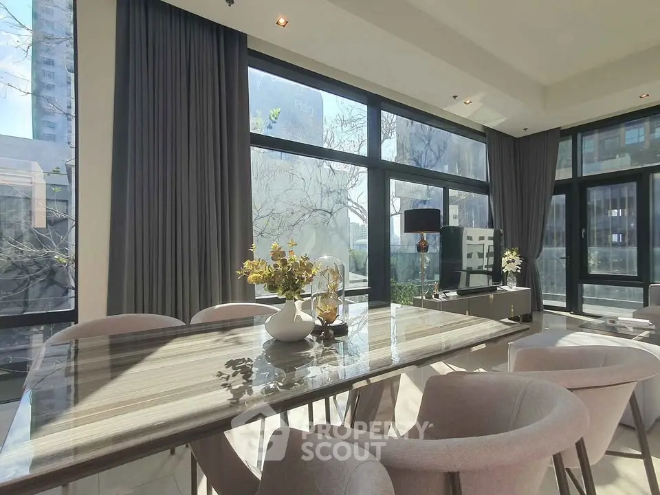 Luxurious modern dining area with large windows and elegant decor in a high-rise apartment.