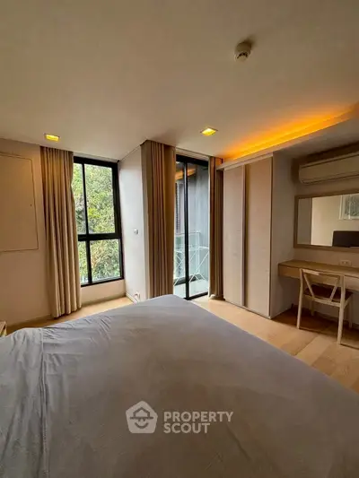 Spacious bedroom with modern decor and balcony access