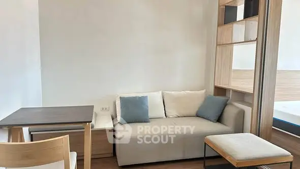 Modern living room with cozy sofa and stylish wooden furniture in a bright apartment.