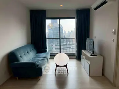 Modern living room with city view, featuring a stylish sofa and sleek entertainment unit.