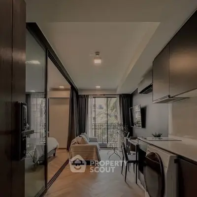 Modern studio apartment with open layout, featuring a cozy living area, compact kitchen, and balcony access.
