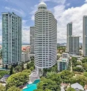 Stunning high-rise building with panoramic city views and lush greenery, featuring a luxurious pool area.