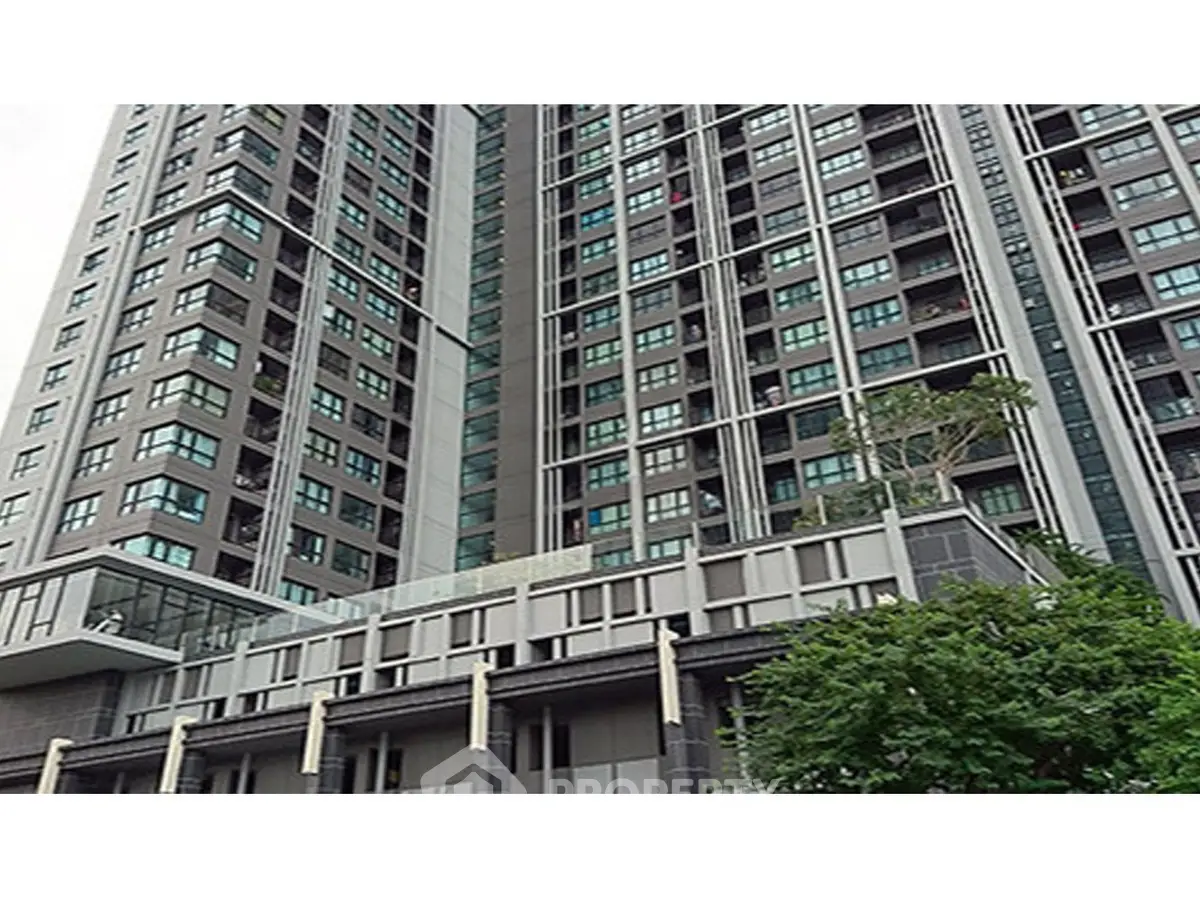 Modern high-rise building exterior with sleek design and large windows.