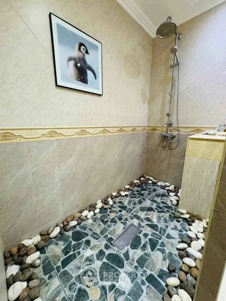 Stylish bathroom with stone floor and modern shower design