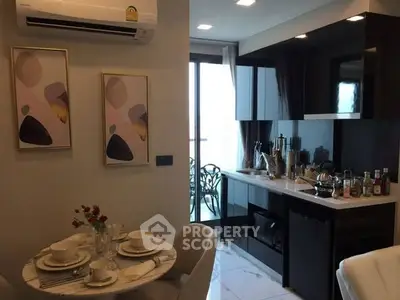 Modern kitchen with sleek black cabinets and dining area in a stylish apartment