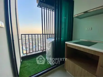 Modern apartment balcony with city view and compact kitchen area.