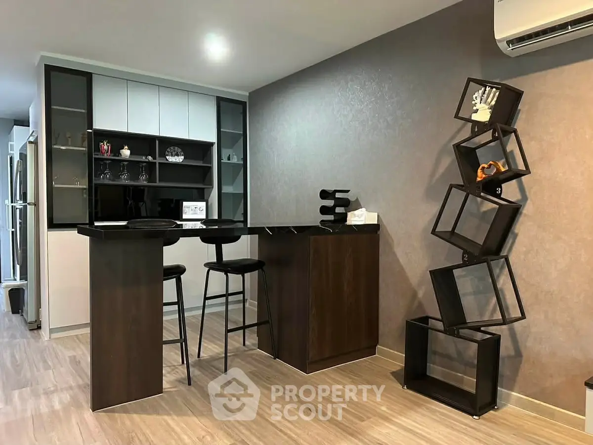 Modern kitchen with sleek bar counter and unique shelving unit