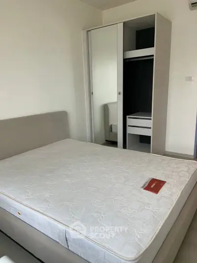 Modern bedroom with sleek wardrobe and comfortable mattress in a stylish apartment.