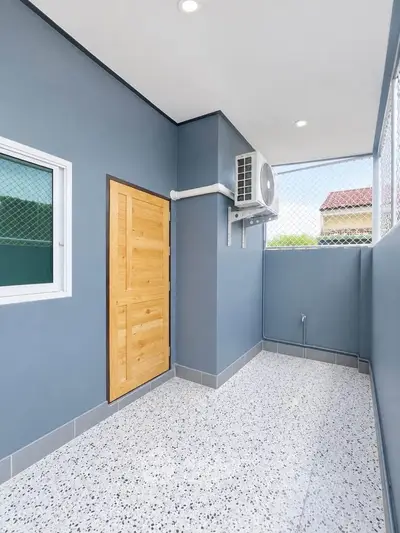 Modern balcony with sleek design and air conditioning unit, perfect for relaxation.