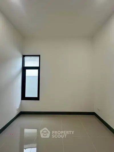 Minimalist empty room with glossy tiled floor and single window, perfect for customization.