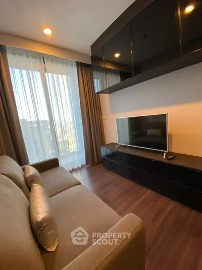 Modern living room with sleek TV unit and cozy sofa, featuring floor-to-ceiling windows and elegant curtains.
