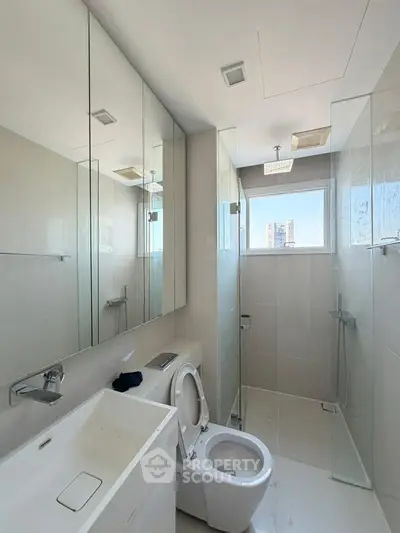 Modern bathroom with sleek fixtures and large mirrors in a bright apartment