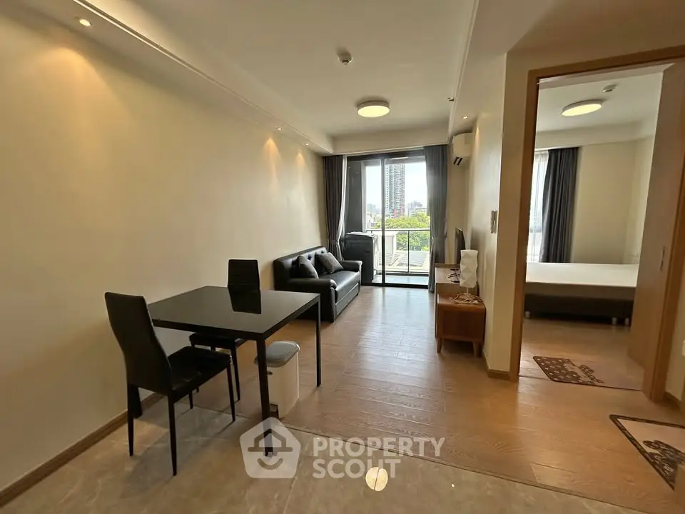 Modern open-plan living room with dining area and balcony view in a stylish apartment.