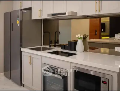 Modern kitchen with sleek appliances and elegant cabinetry