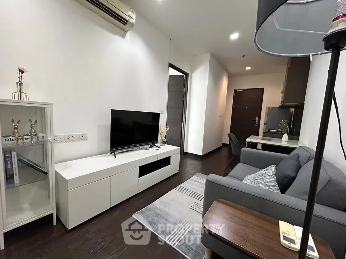 Modern living room with sleek furniture and stylish decor in a contemporary apartment.