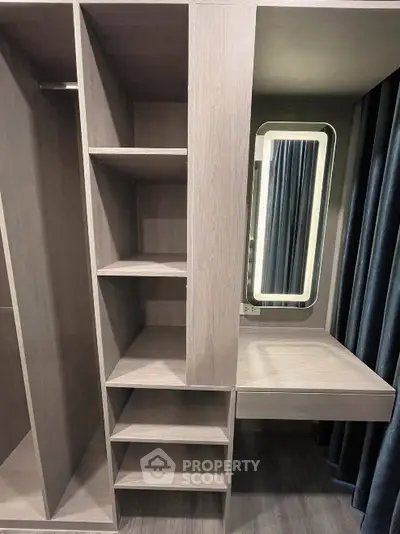 Modern walk-in closet with built-in shelves and vanity mirror